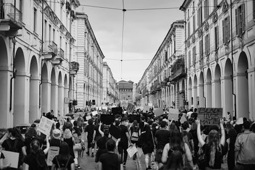 Grayscale Photo of People Protesting on the Street
