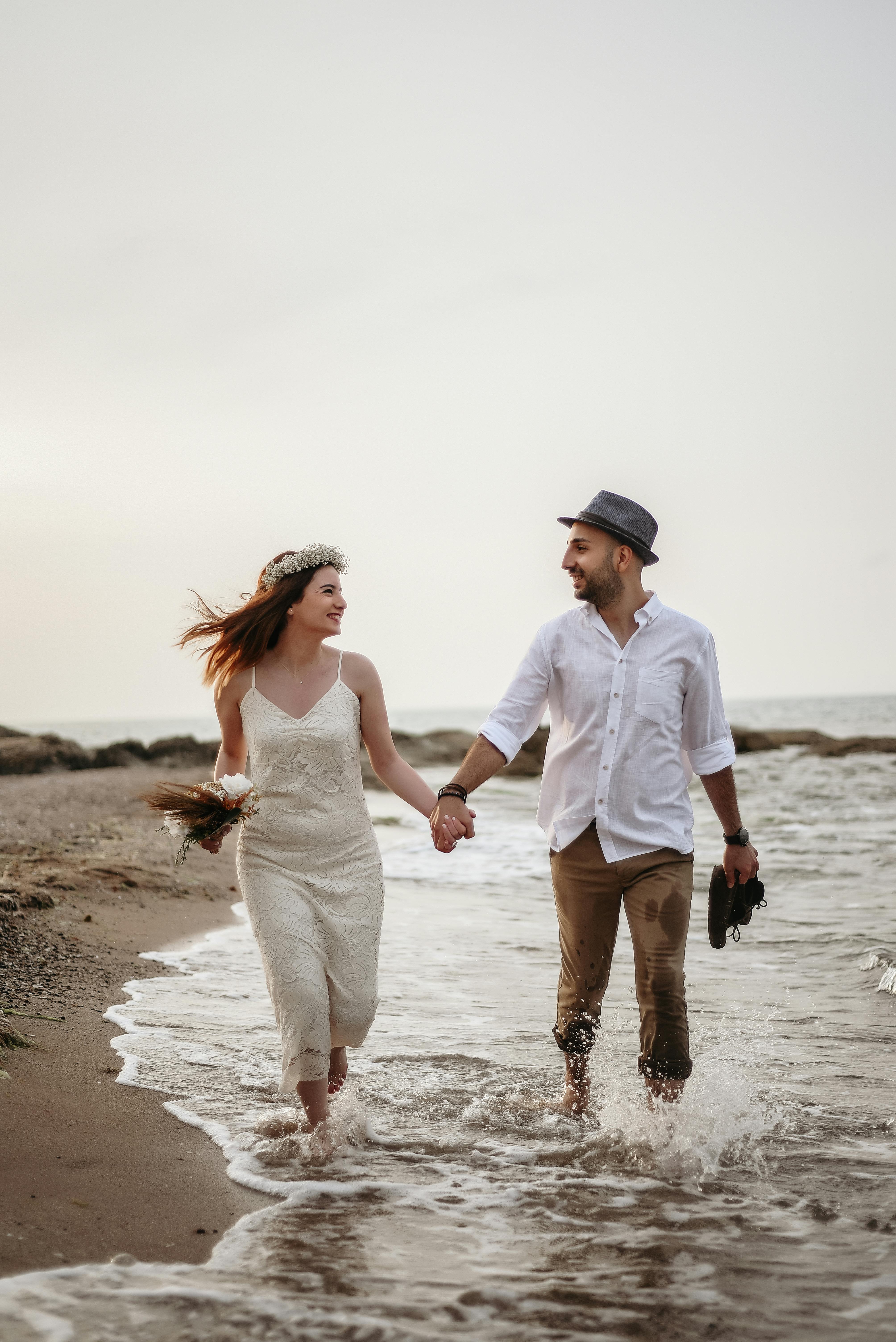 happy couple walking on seaside