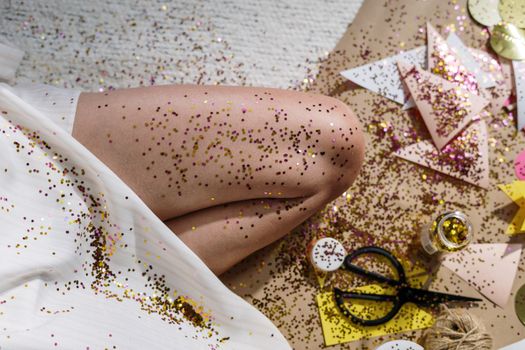 Colorful DIY craft session featuring glitter confetti and paper crafts indoors.