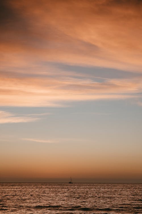 Boat on the Horizon at Sunset