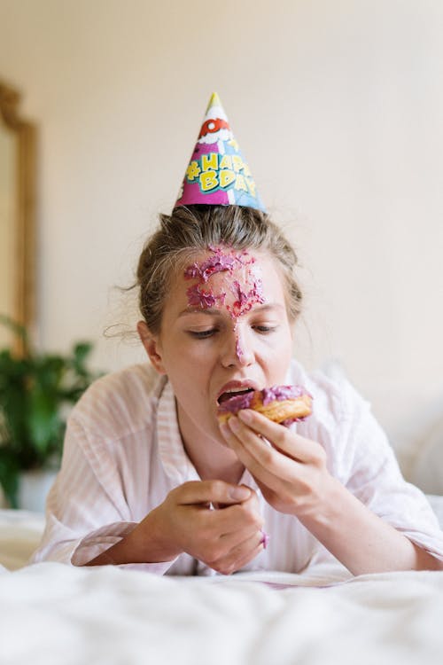 Free Woman in White Shirt Eating Bread Stock Photo