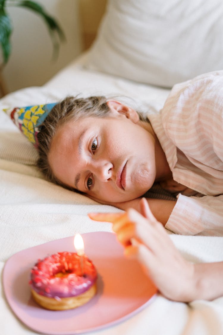 Girl Lying On Bed With Red Rose Petals