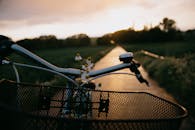 Bicycle moving through green plants in countryside