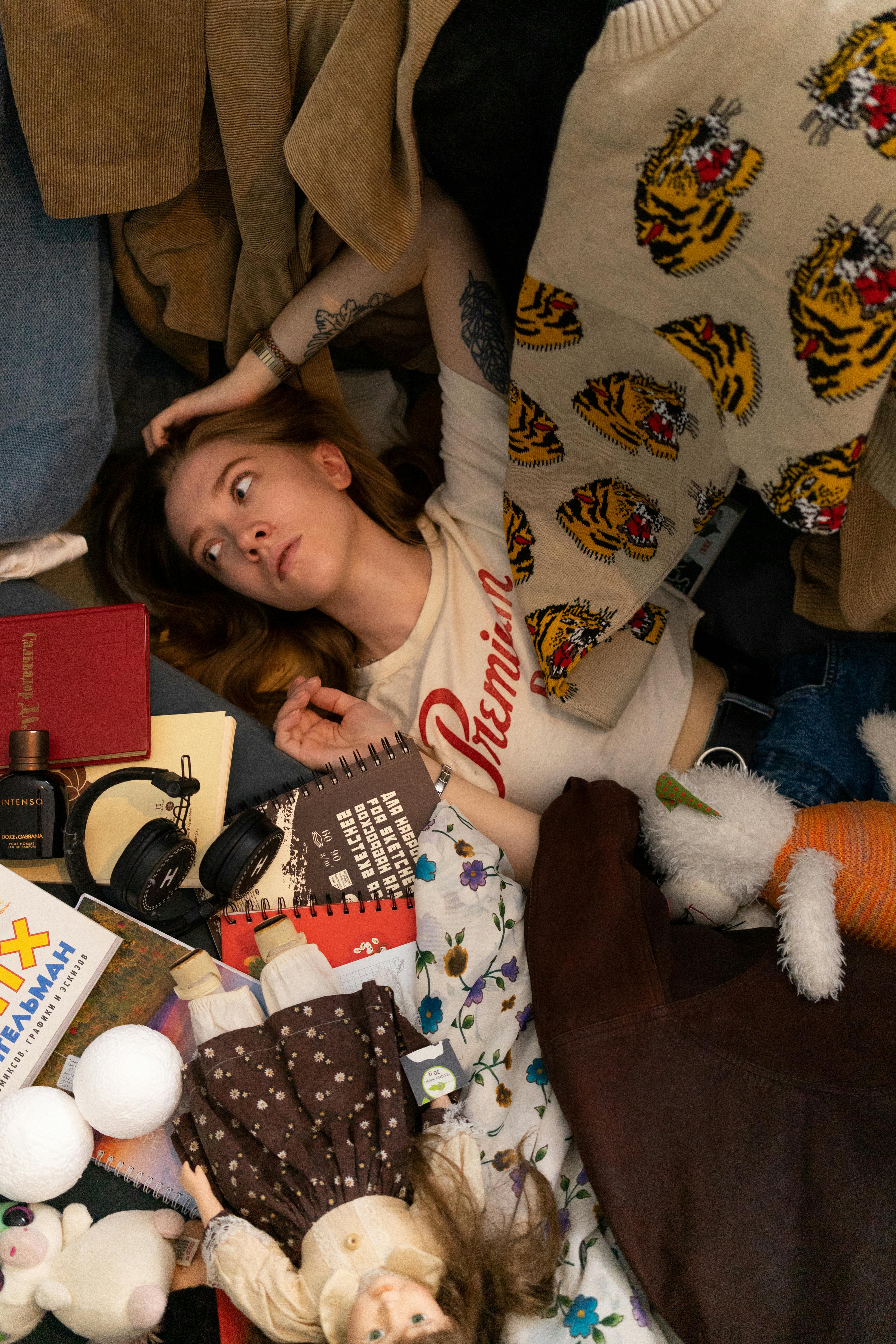 cute girl lying on messy floor