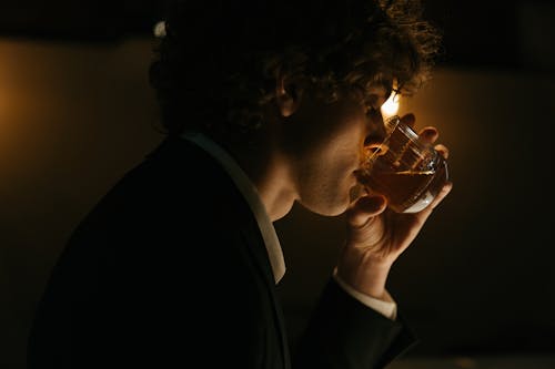 Man In Black Shirt Drinking Beer