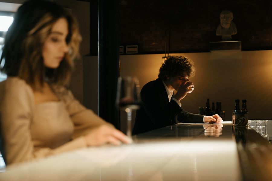 Adult woman and mature gentleman enjoying a calm conversation over drinks