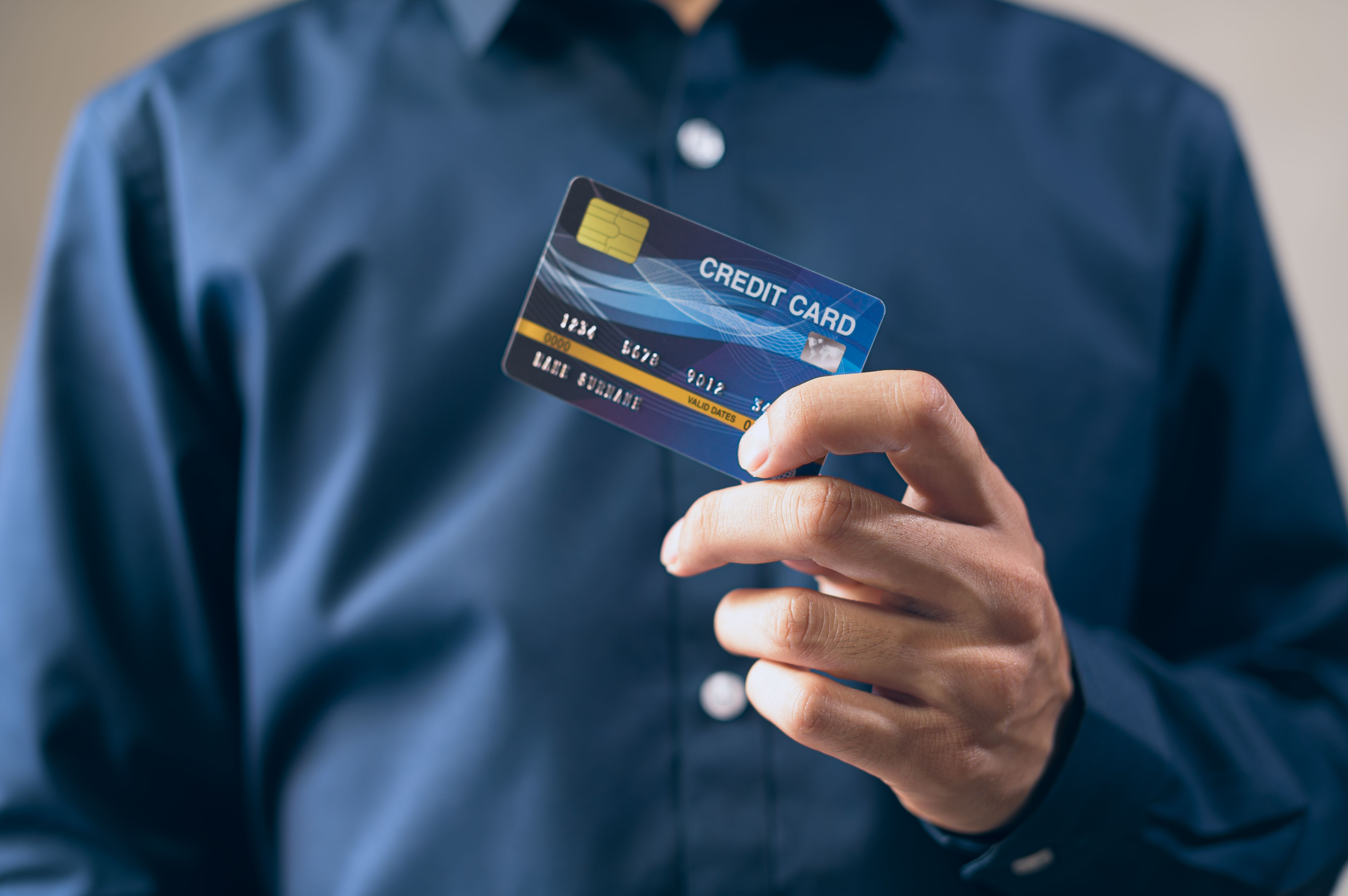 Close-up of a hand holding an Aspire Credit Card style unsecured card