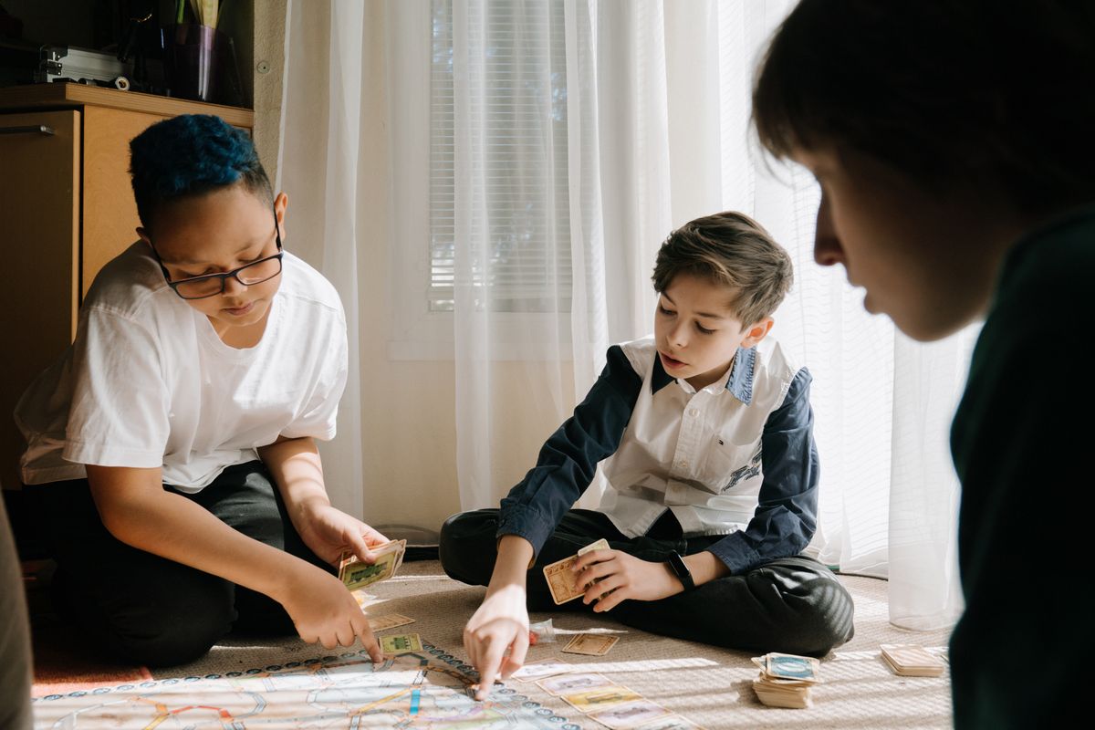Kids playing a portable card game while traveling
