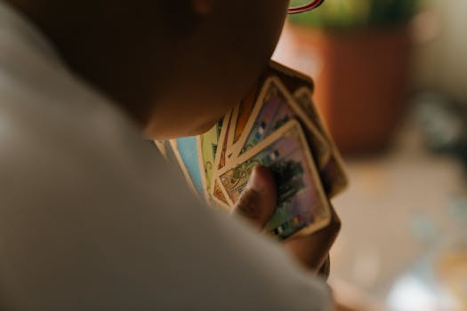 A child engaged in playing a card game indoors, focused on strategy and fun.