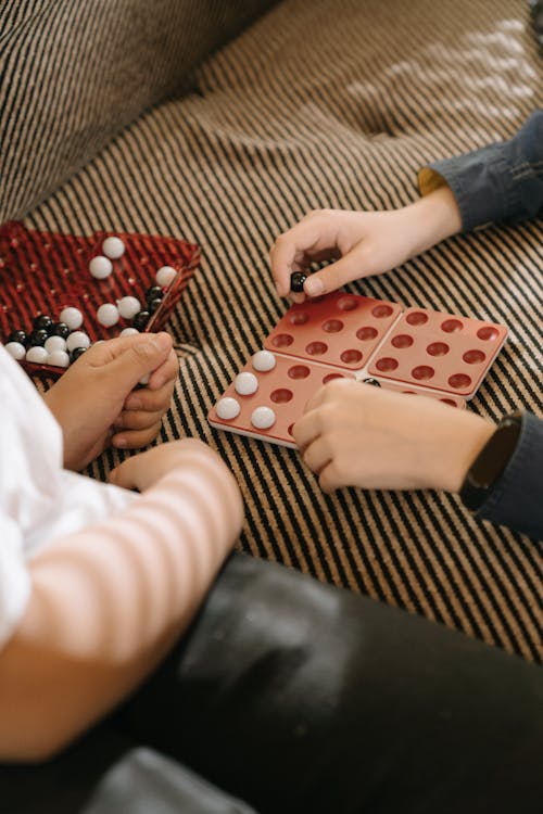 Person Holding Red and White Polka Dot Gift Wrapper