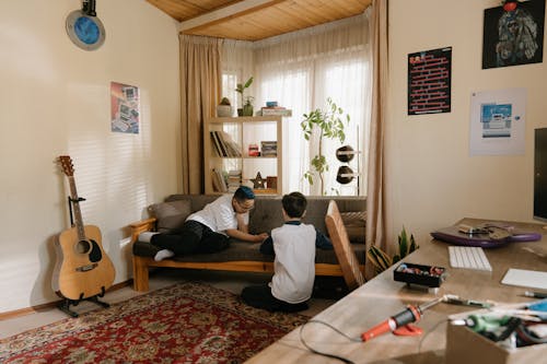 Man in White T-shirt Sitting on Couch