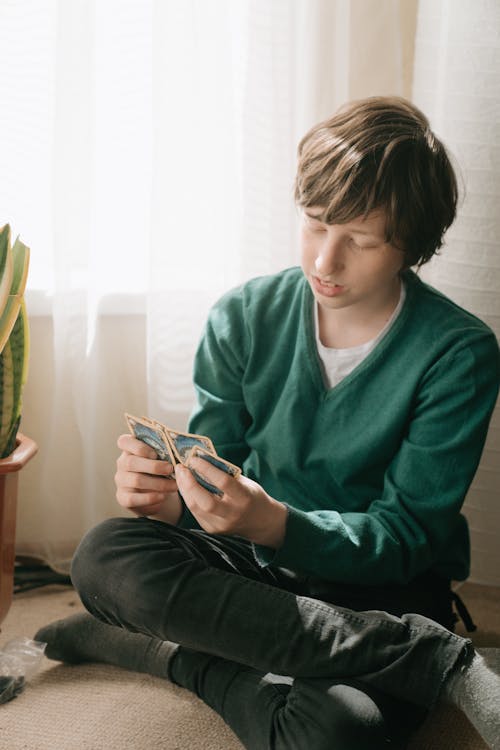 Woman in Green Sweater Holding Smartphone