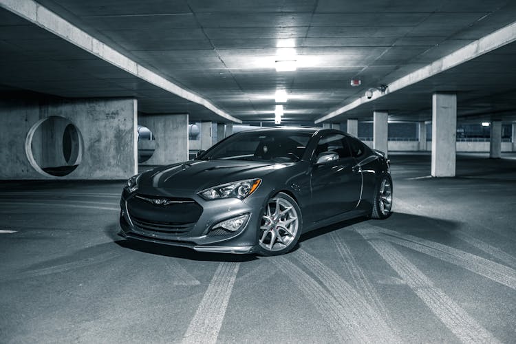 Sport Car In Center Of Parking Zone