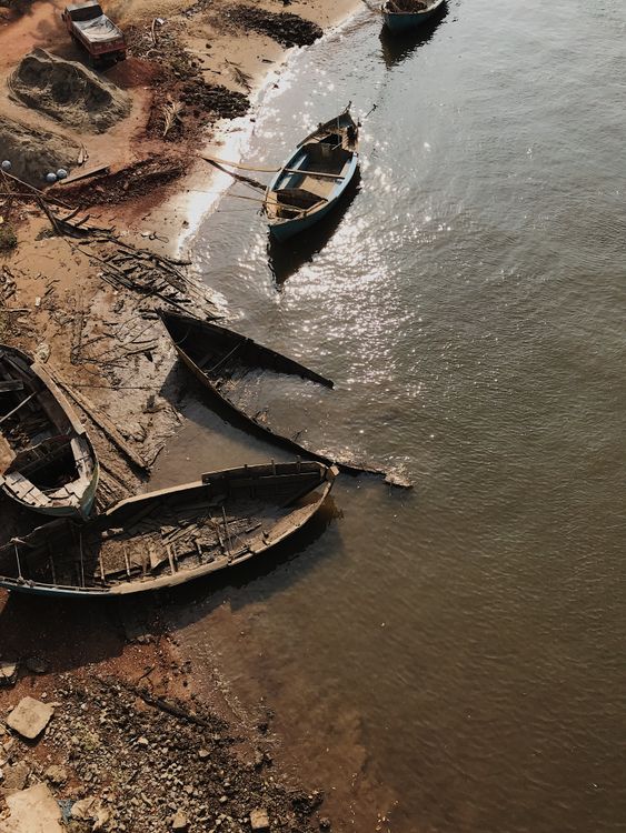 Brown Wooden Boats on Body of Water · Free Stock Photo