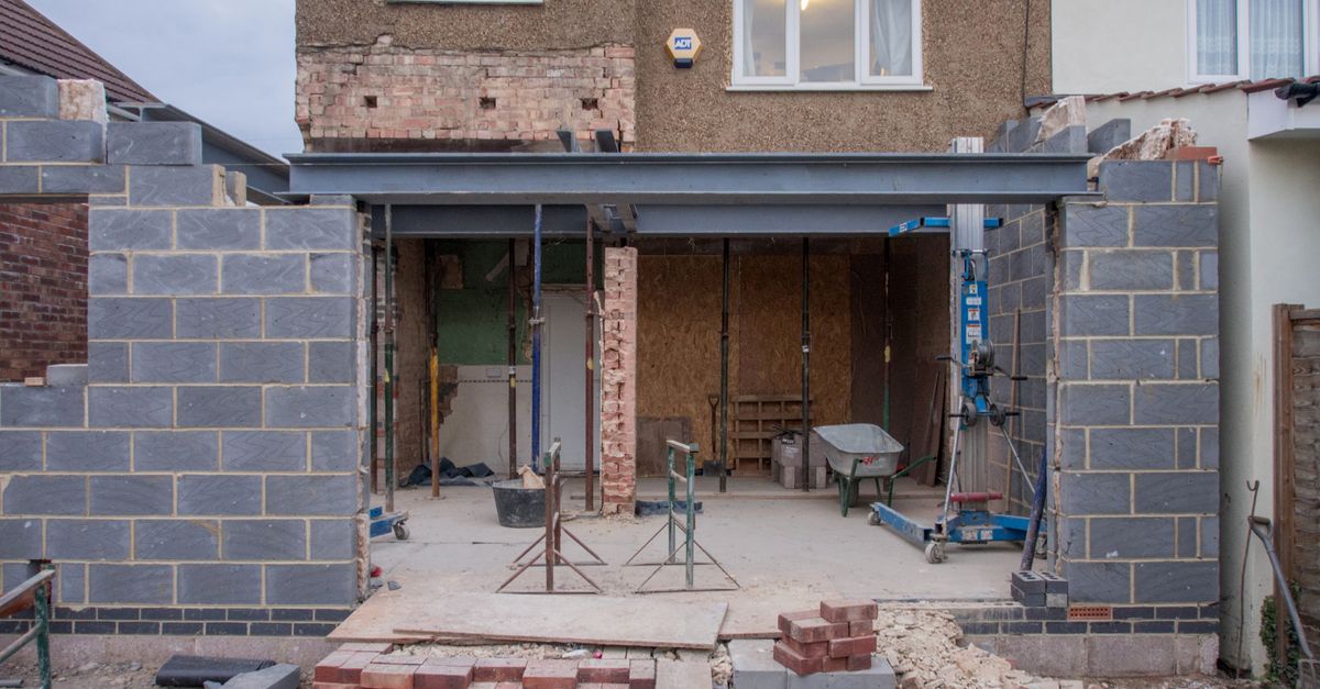 Brick house extension under construction with materials on site — extensions and renovations are high-value projects won on trust and proof