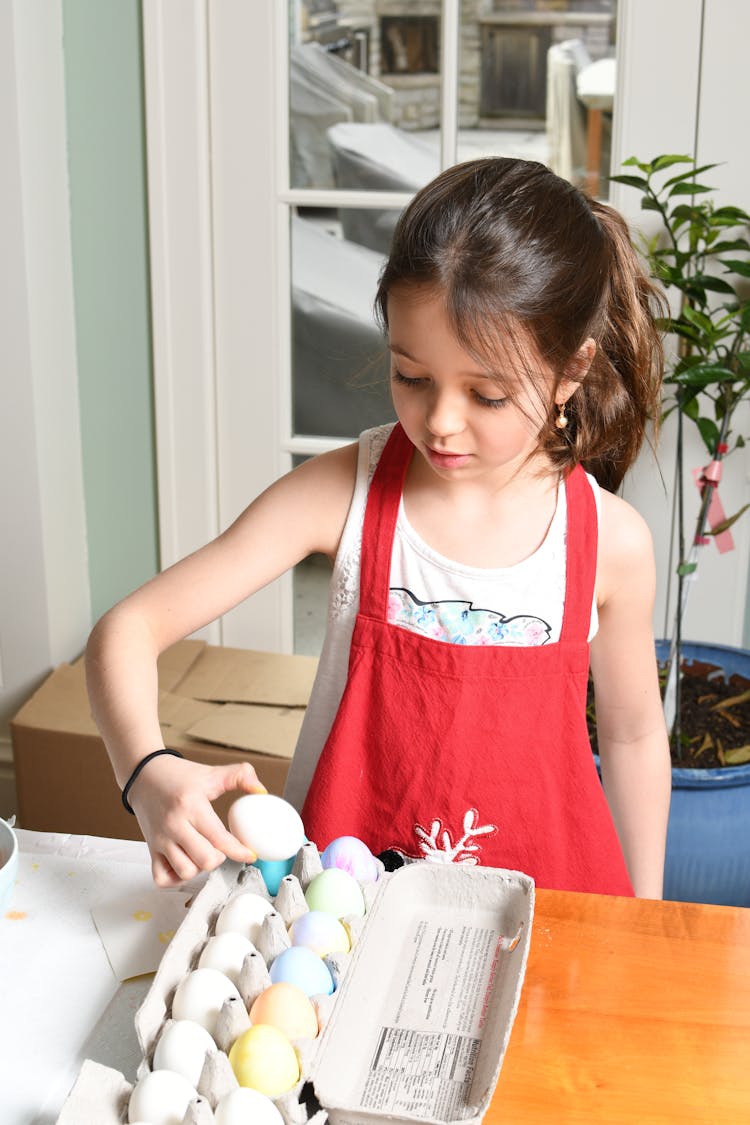 Young In Red Apron Cooking Eggs