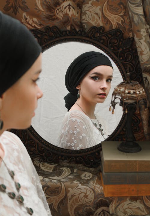 Элегантная женщина смотрит в зеркало