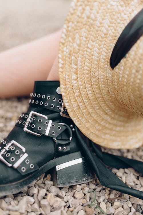 Close Up Photo of Person Wearing Black Leather Boots