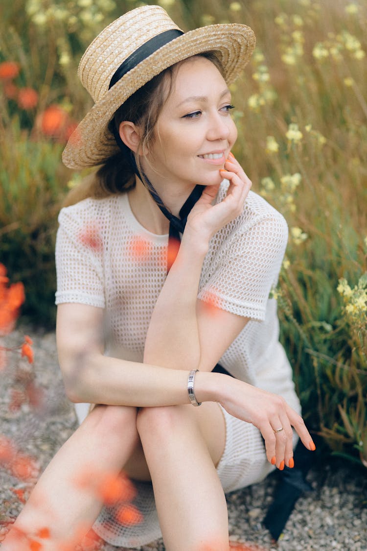 Woman In White Mesh Shirt And Straw Summer Hat