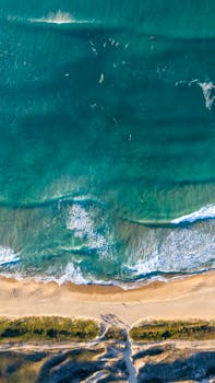 Breathtaking aerial view of the waves and shore at Campeche Beach, Brazil.