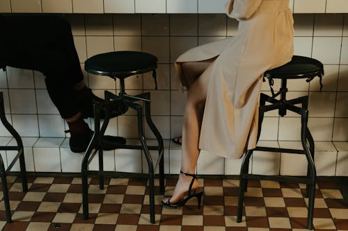 Woman in White Robe Sitting on Chair