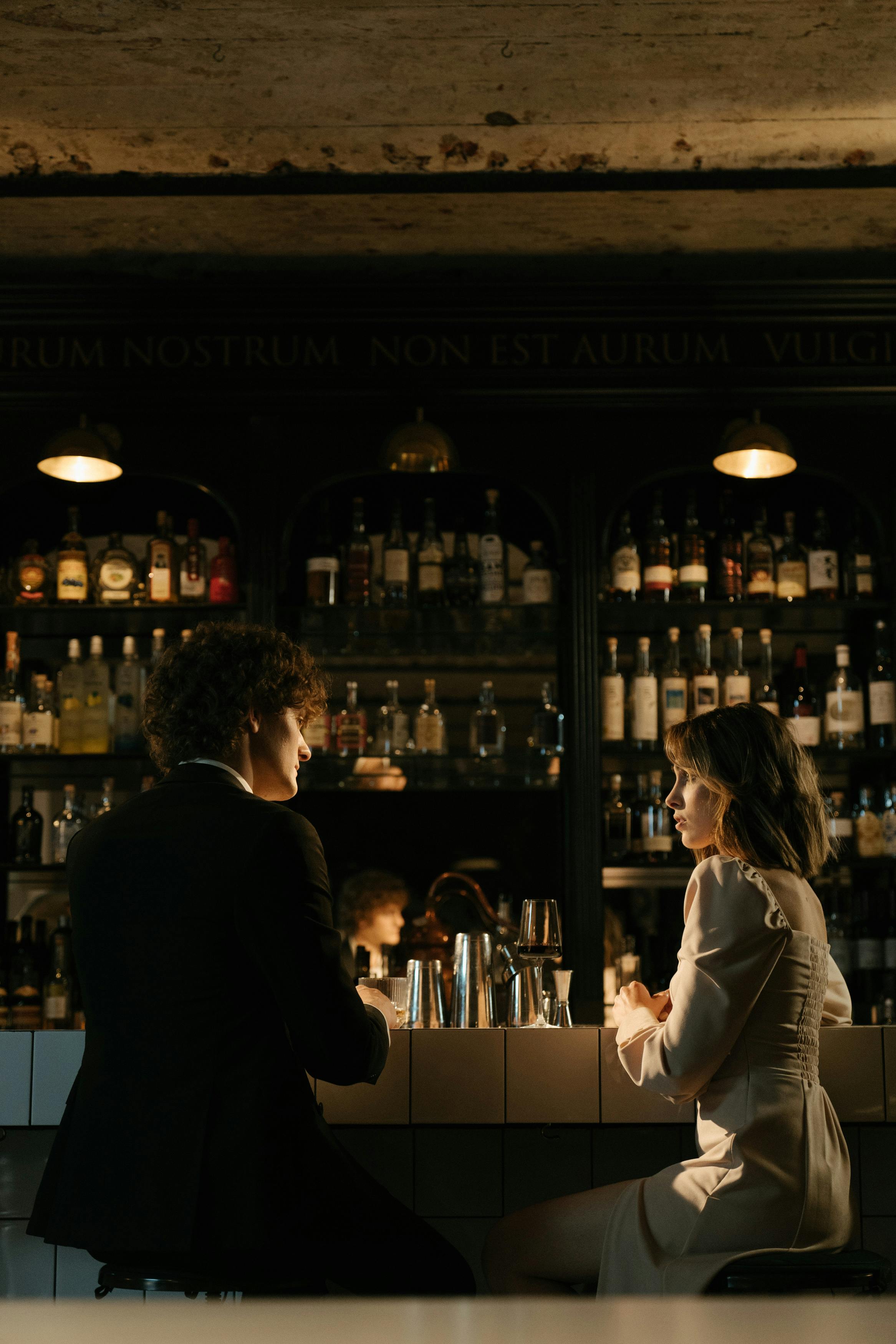 man in black suit jacket standing beside woman in white long sleeve shirt