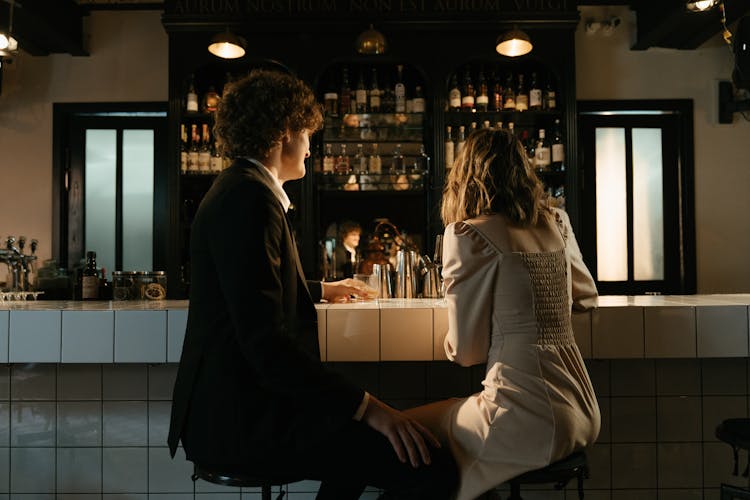 Man And Woman Sitting On Counter