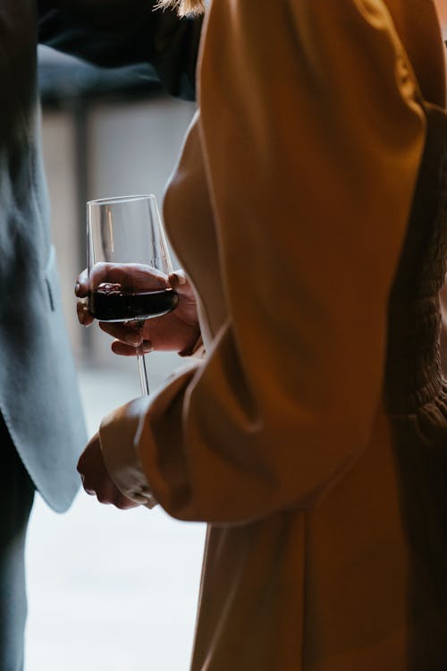 Man in Brown Suit Holding Wine Glass