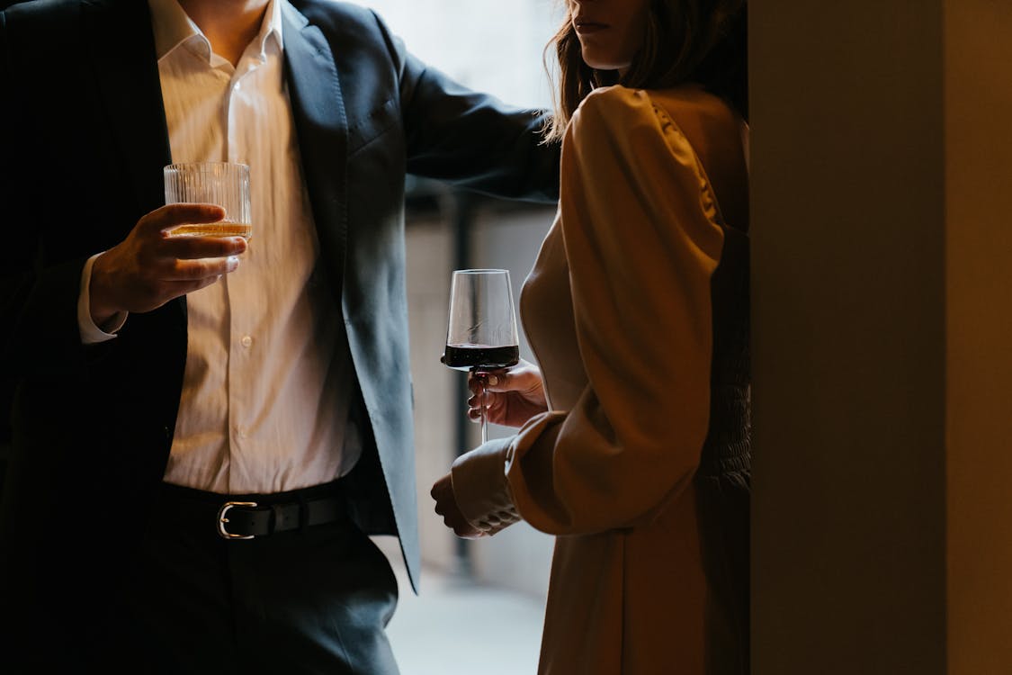 Free Woman in White Dress Shirt and Black Blazer Holding Clear Drinking Glass Stock Photo