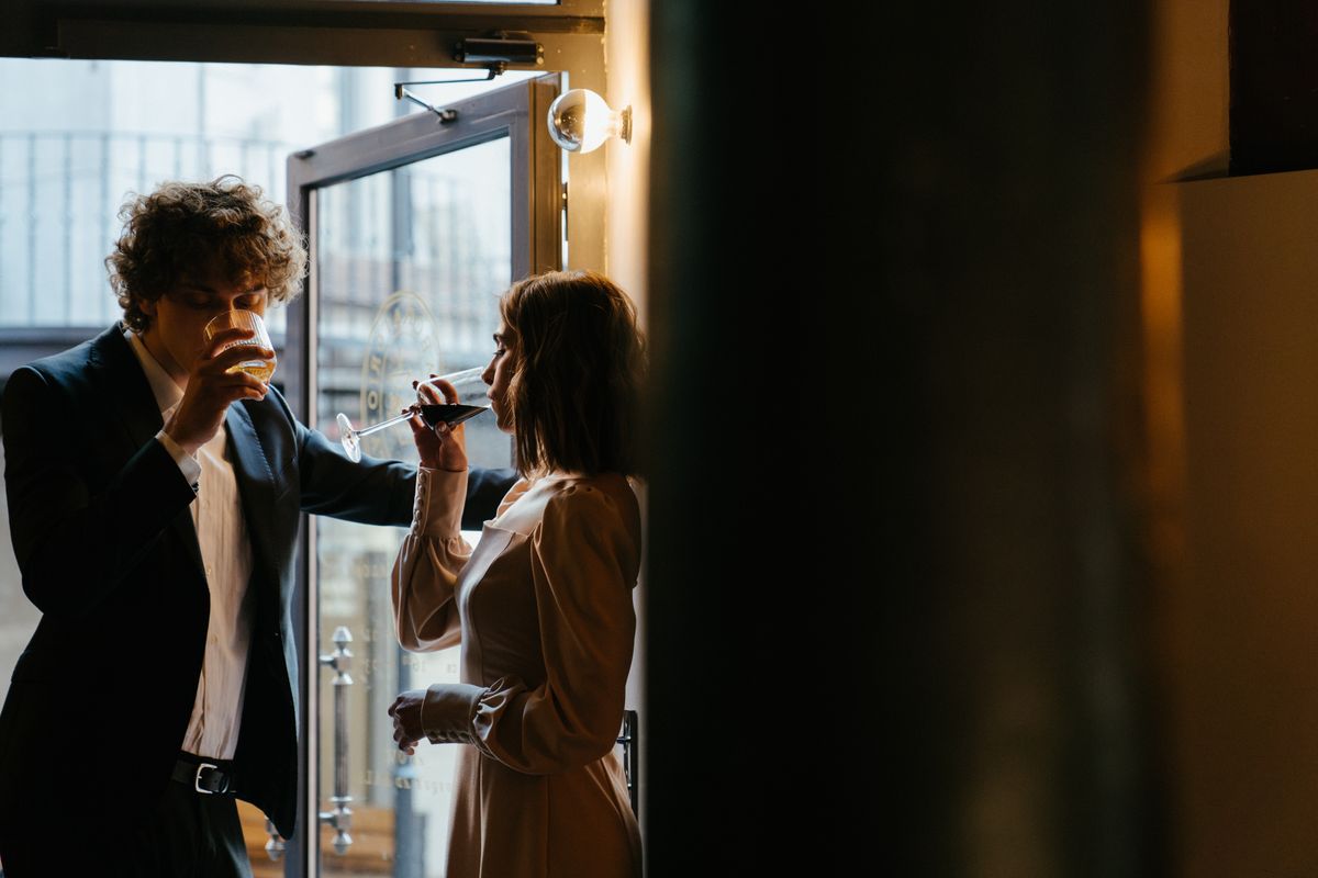 Young stylish couple enjoying cocktails in an elegant bar