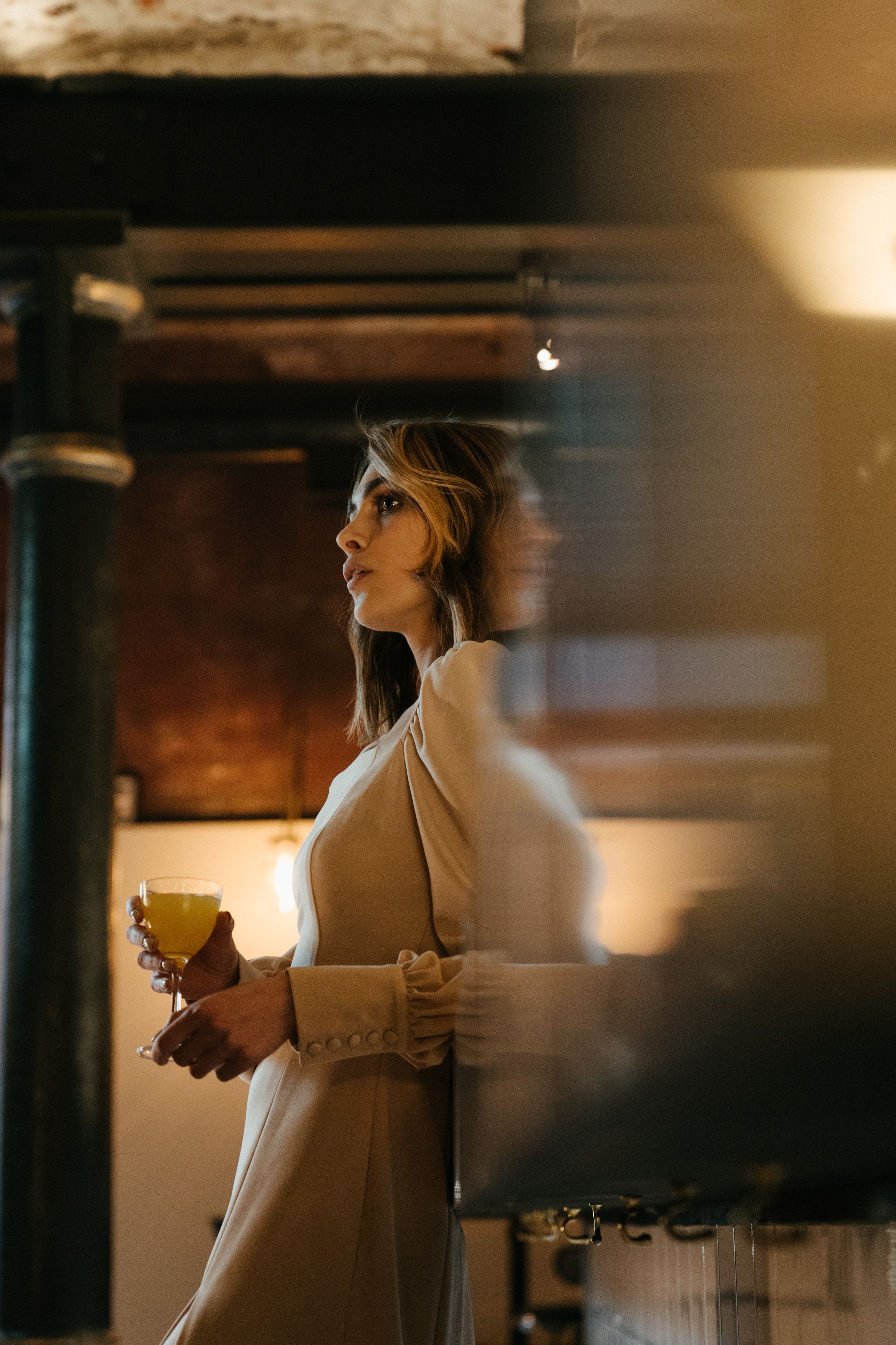 Woman in White Long Sleeve Shirt Holding Glass Cup · Free Stock Photo