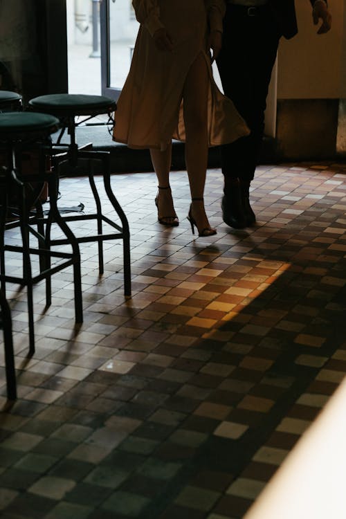 Person in White Coat Standing Near Table