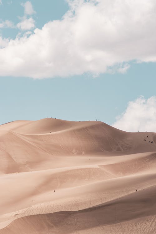 Photo of Desert Under White Clouds