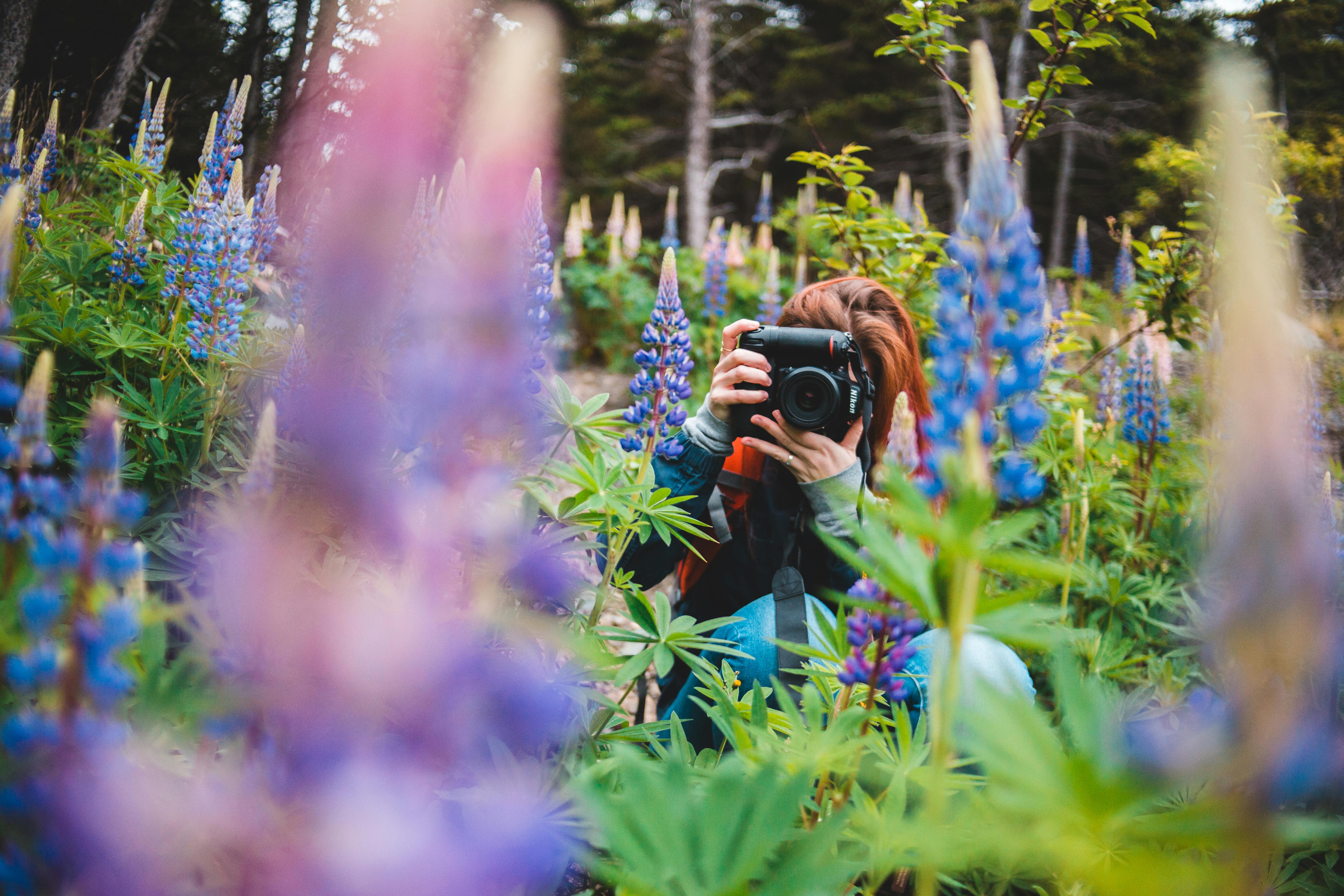 selective focus photo of person using black camera