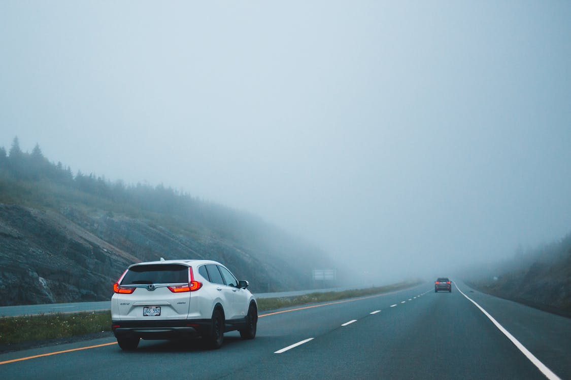 Photo of Vehicles on Road During Foggy Weather