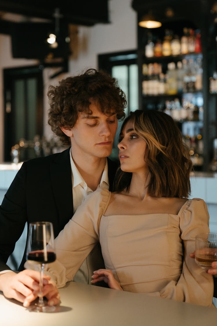 Man In Black Suit Kissing Woman In White Dress