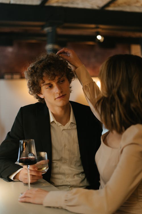 Woman in White Blazer Holding Clear Wine Glass