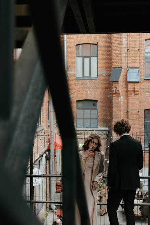 Man in Black Suit Standing Beside Woman in White Dress