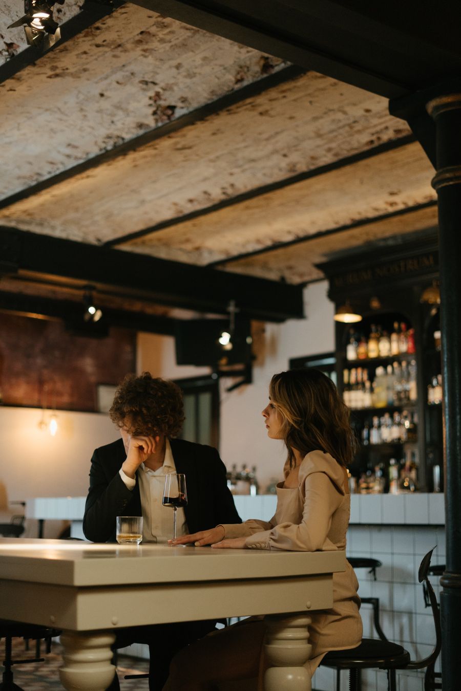 Stylish adult couple sharing a drink in a warm evening setting