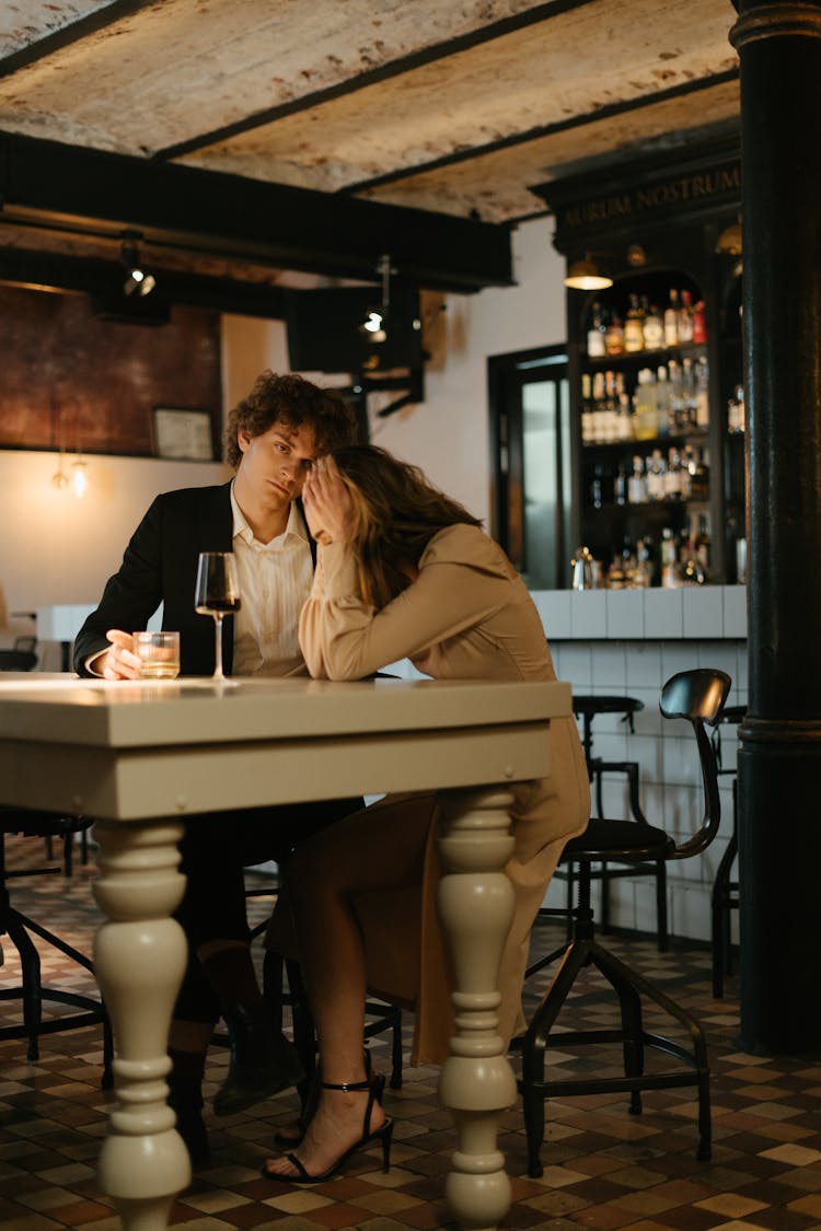 Man And Woman Sitting At Table