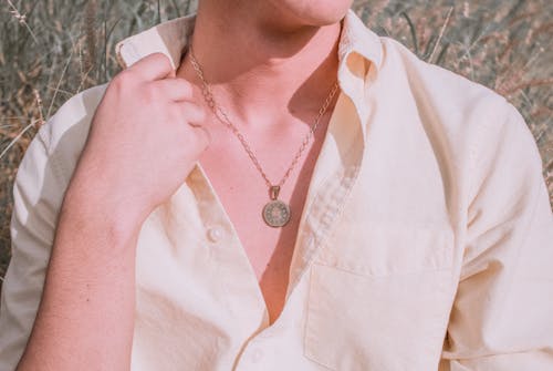 Free Person in White Button Up Shirt Wearing Necklace Stock Photo
