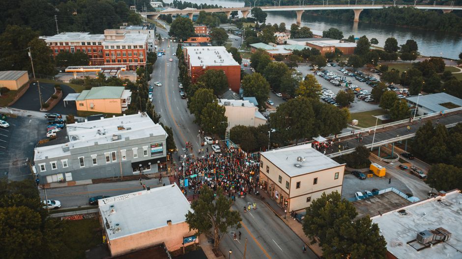 Amazing The Smoky Mountain Valley Adventure by Helicopter Review: Your Complete Guide to Tennessee's Most Scenic Flight Review 2026 - Aerial view of unrecognizable group of people on road during manifestation between buildings in city