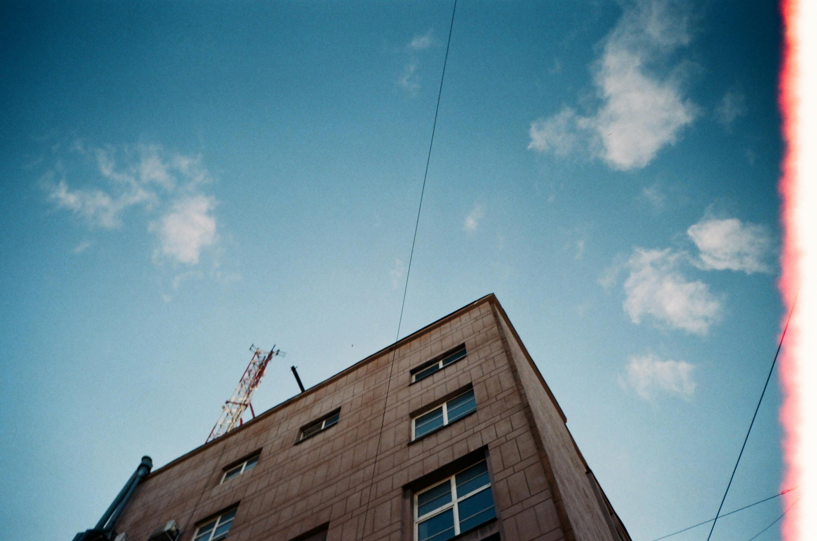 Low angle view of a building in Saint Petersburg against a blue sky, showcasing urban architecture.