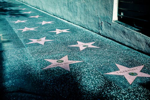 Free Pink Stars on Gray Tiled Street Sidewalk  Stock Photo