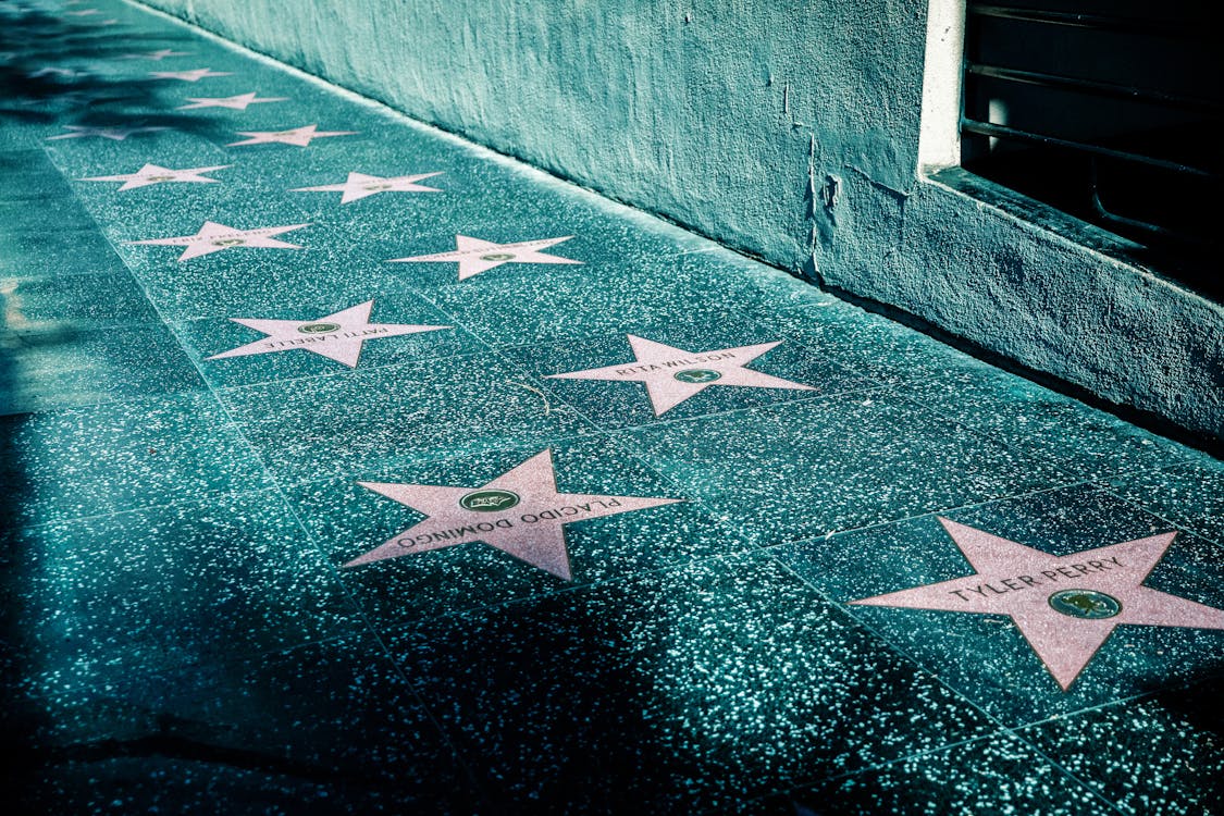 Free Pink Stars on Gray Tiled Street Sidewalk  Stock Photo