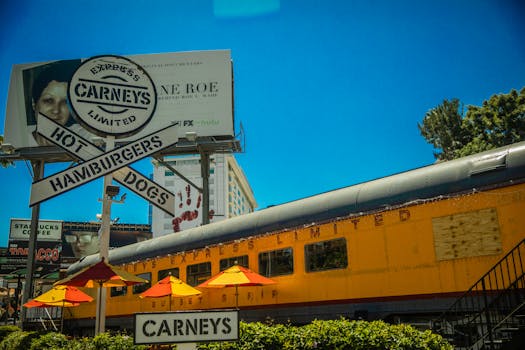 Iconic Los Angeles Carney's restaurant featuring train car dining and bold signage.