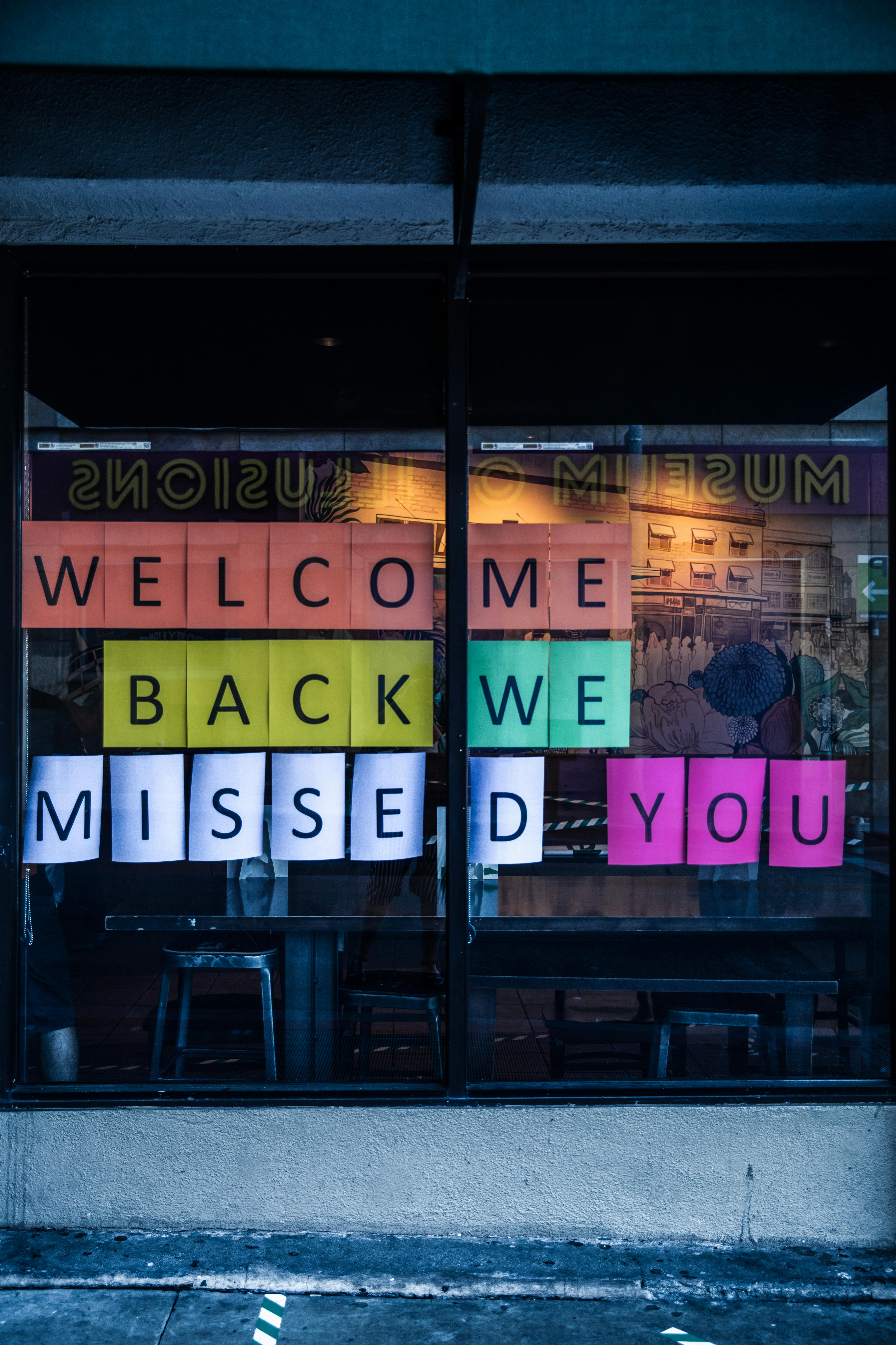 a welcome sign on a shop window