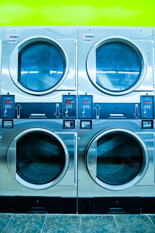Laundry Management System — Commercial washing machines in a laundromat