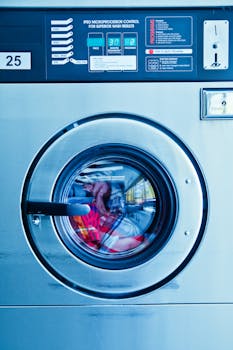 Close-up view of a washing machine in a modern laundromat setting in Los Angeles.