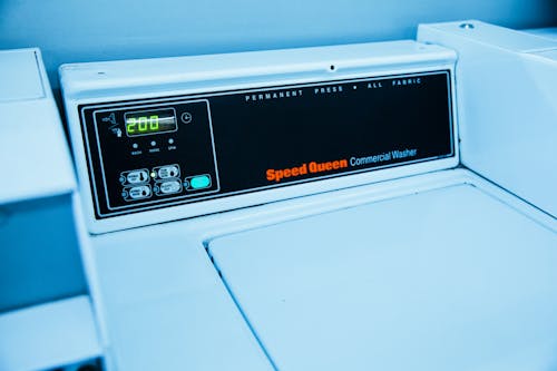 White Washing Machine on Laundry Mat